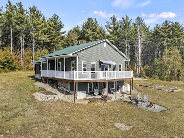 view of front of house with a patio, a deck, and a front lawn