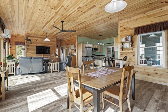 dining area with ceiling fan, wooden ceiling, a wall mounted air conditioner, wood-type flooring, and wooden walls