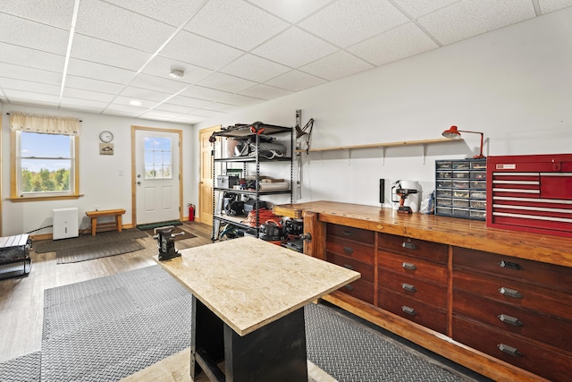 interior space with a paneled ceiling and wood-type flooring