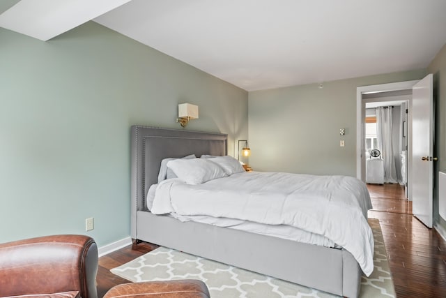 bedroom with dark hardwood / wood-style flooring