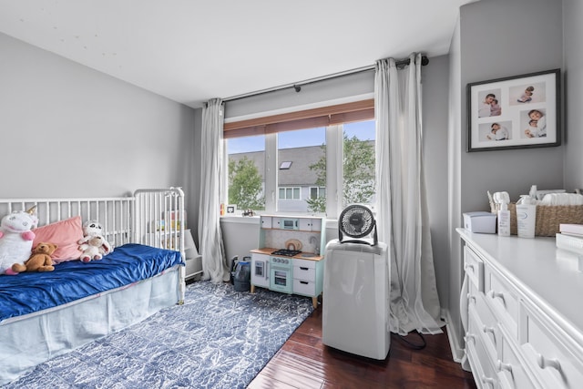 bedroom with dark hardwood / wood-style floors