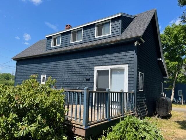 rear view of house featuring a wooden deck