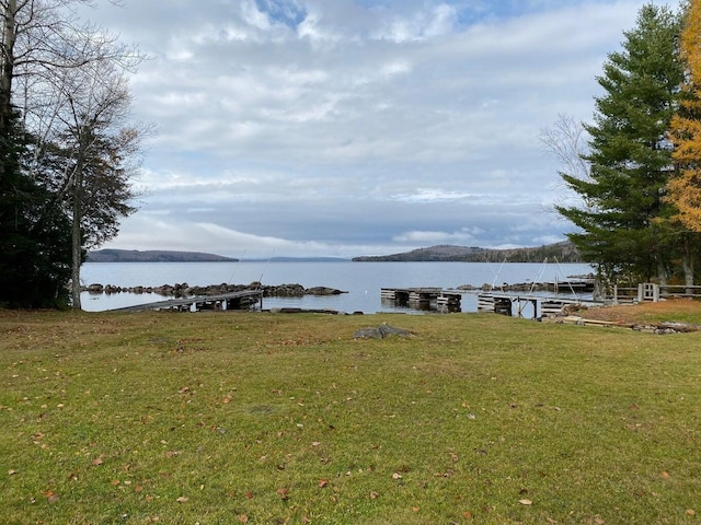 exterior space featuring a water view and a lawn