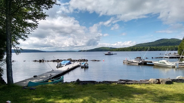 view of dock with a water and mountain view