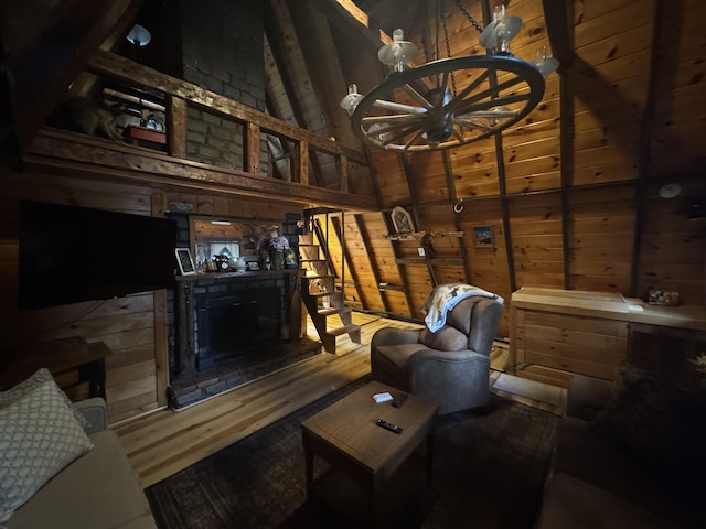 living room featuring wood walls, wood ceiling, and vaulted ceiling