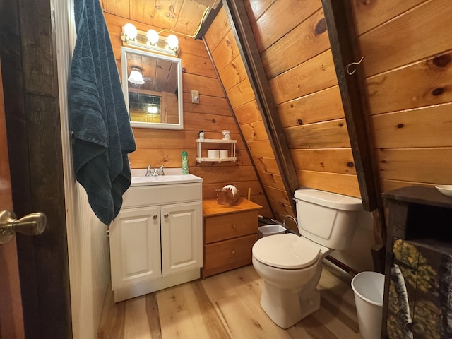 bathroom featuring wood walls, wood-type flooring, vaulted ceiling, vanity, and wood ceiling