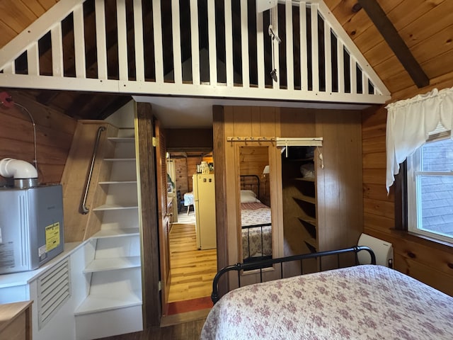 bedroom featuring lofted ceiling with beams, wood walls, hardwood / wood-style floors, and wooden ceiling