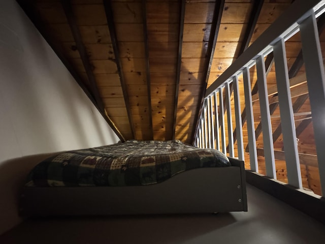 unfurnished bedroom featuring vaulted ceiling with beams and wood ceiling