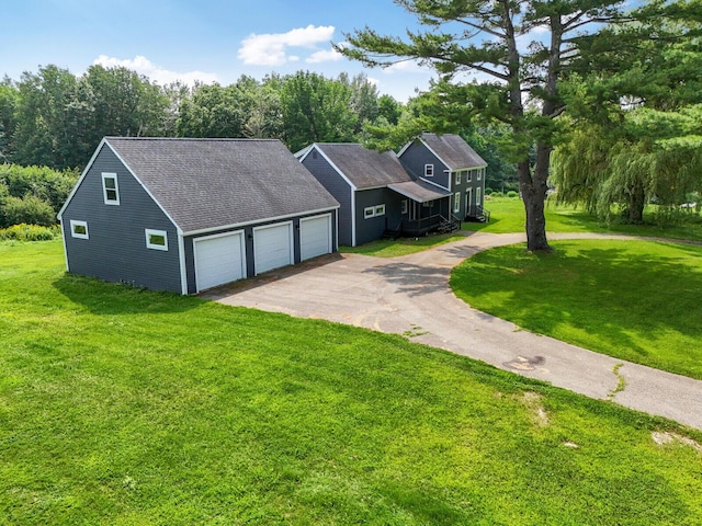 view of front of home with a front yard and a garage