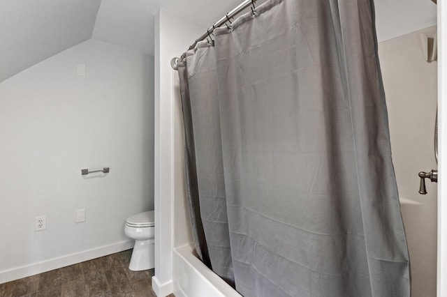 bathroom with shower / bathtub combination with curtain, lofted ceiling, and toilet