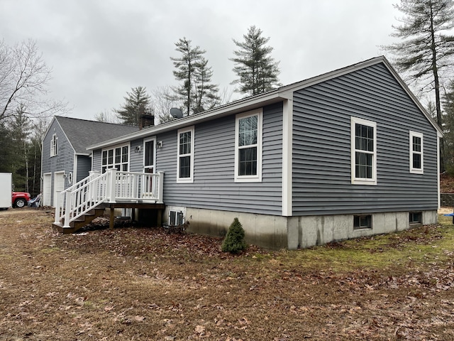 exterior space with a garage and central AC