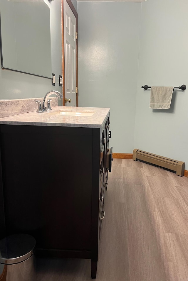 bathroom with vanity, a baseboard radiator, and toilet