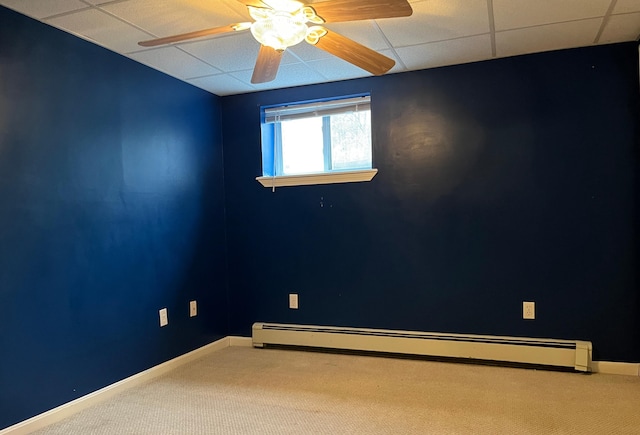 carpeted spare room featuring a baseboard radiator and ceiling fan