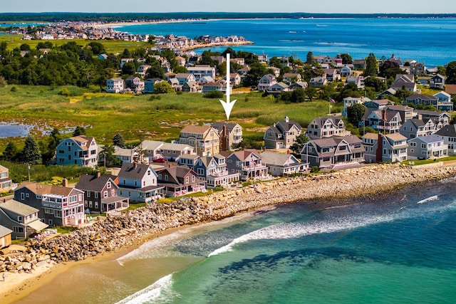 drone / aerial view featuring a water view and a beach view