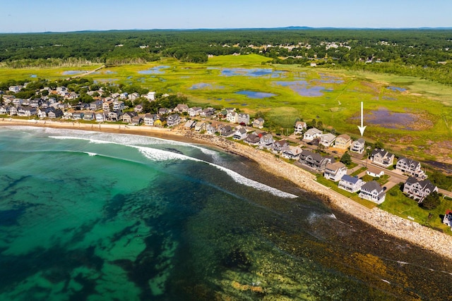 aerial view with a water view and a beach view