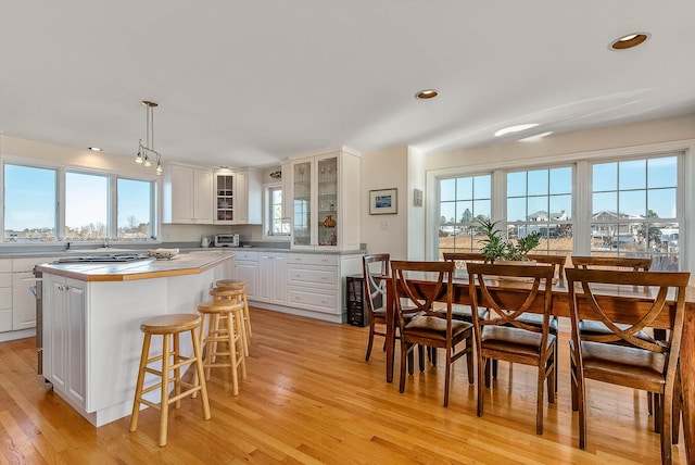 kitchen featuring white cabinets, plenty of natural light, pendant lighting, and a kitchen island