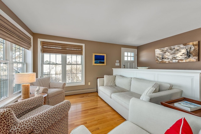 living room with baseboard heating and light hardwood / wood-style flooring