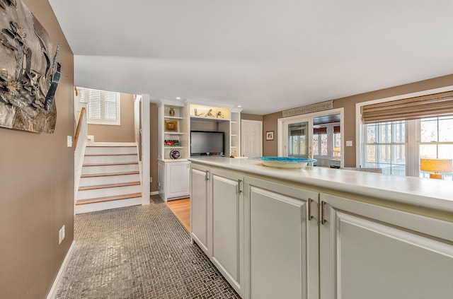 kitchen featuring white cabinetry and light tile patterned flooring