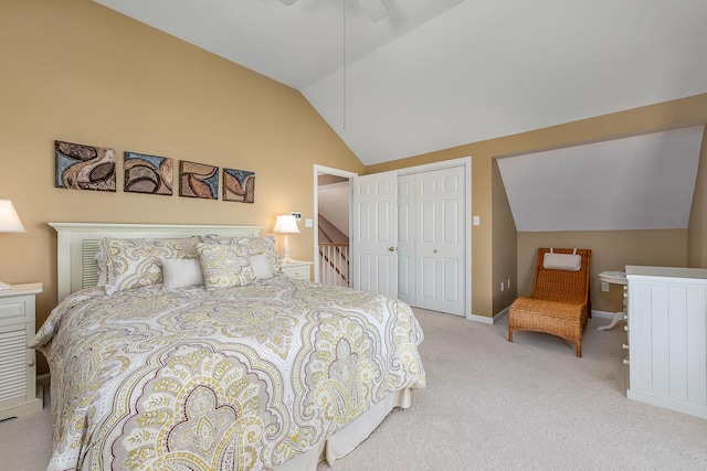 carpeted bedroom featuring ceiling fan, a closet, and lofted ceiling