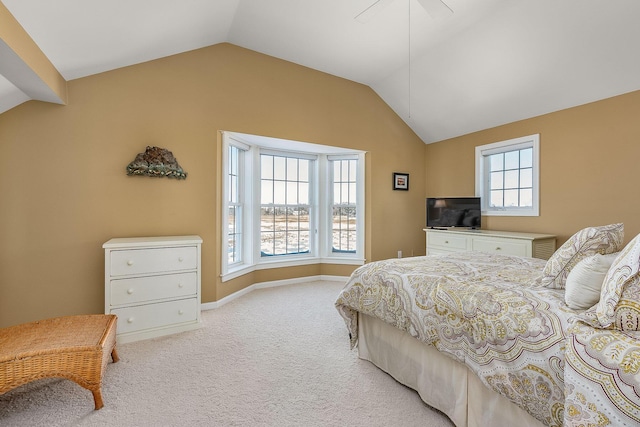 bedroom featuring multiple windows, light colored carpet, ceiling fan, and lofted ceiling