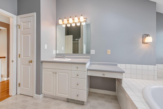 bathroom with vanity and shower with separate bathtub