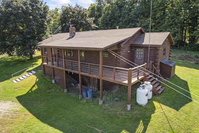 rear view of house featuring a yard and a wooden deck