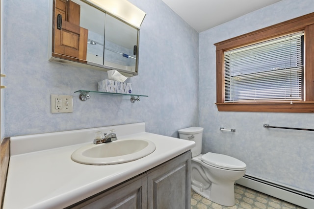 bathroom with baseboard heating, vanity, and toilet