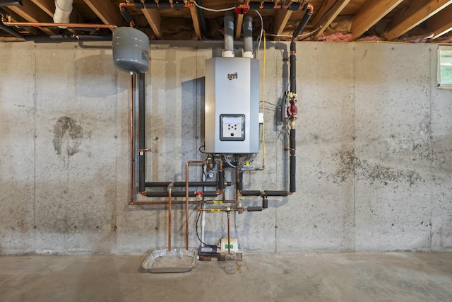 utility room featuring water heater