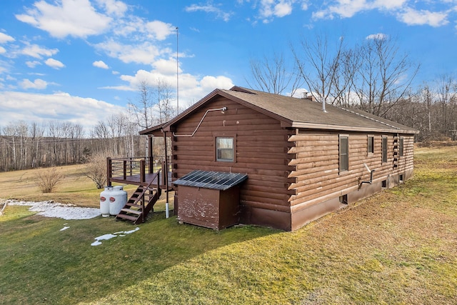 view of side of property with a lawn and a wooden deck