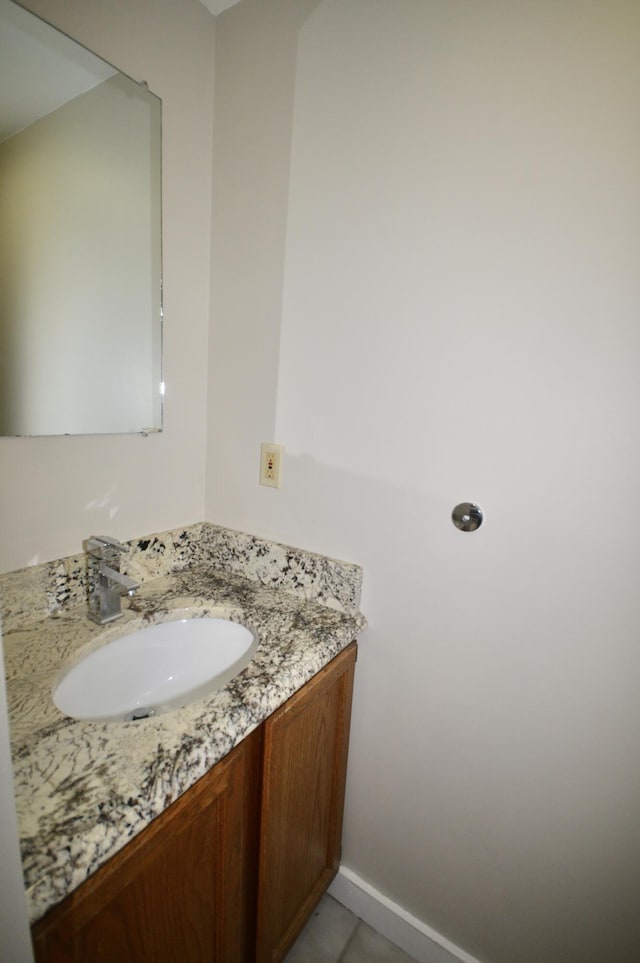 bathroom featuring tile patterned flooring and vanity