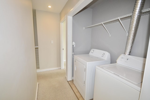 laundry area featuring light carpet and washer and dryer