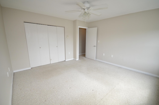 unfurnished bedroom featuring carpet, a closet, and ceiling fan