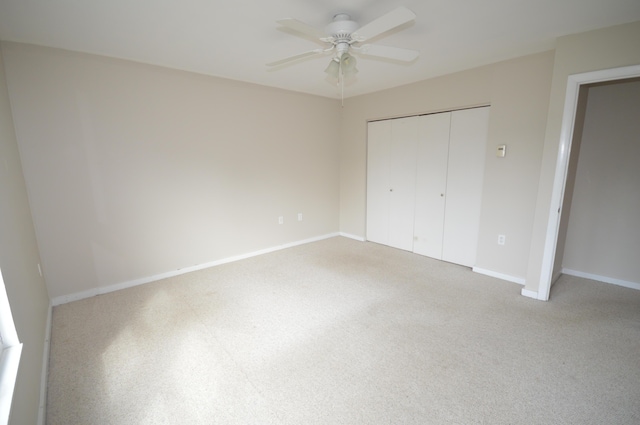 unfurnished bedroom with carpet, a closet, and ceiling fan