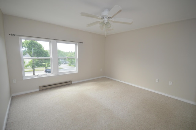 unfurnished room with ceiling fan, carpet, and a baseboard radiator