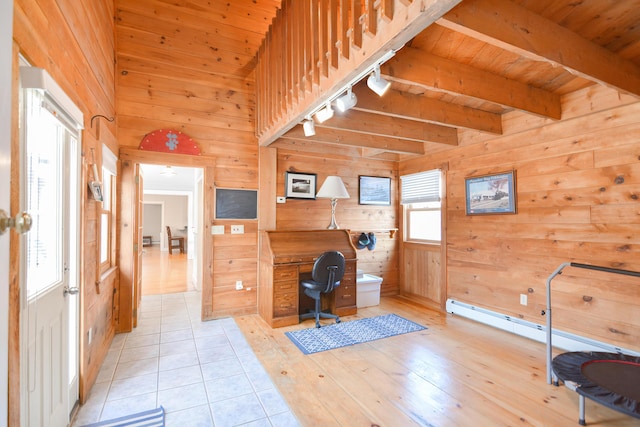 unfurnished office featuring track lighting, wood walls, light tile patterned floors, wood ceiling, and beamed ceiling