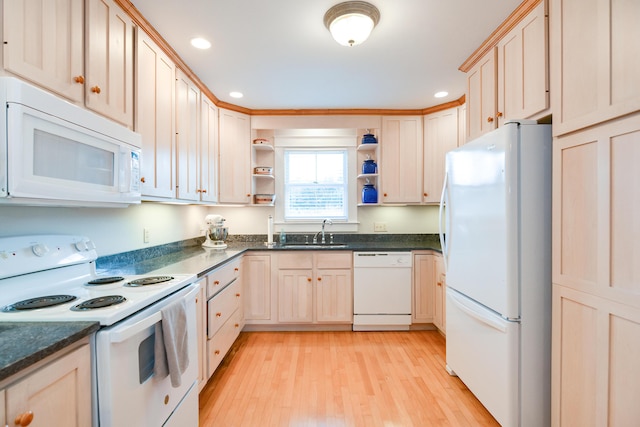 kitchen featuring white appliances, light hardwood / wood-style floors, light brown cabinetry, and sink