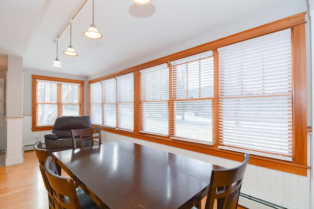 dining space with light wood-type flooring and a baseboard radiator