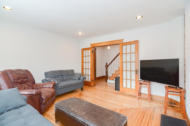 living room with french doors, parquet flooring, and a baseboard heating unit