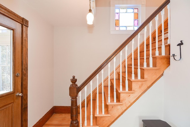 stairs featuring hardwood / wood-style floors