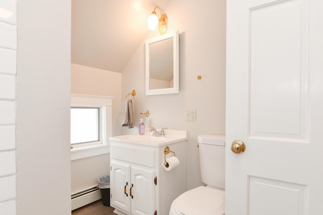 bathroom featuring vaulted ceiling, a baseboard radiator, vanity, and toilet