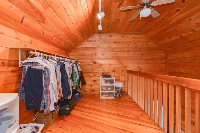 walk in closet with light hardwood / wood-style floors, ceiling fan, and vaulted ceiling