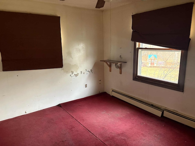 unfurnished room featuring ceiling fan and a baseboard heating unit