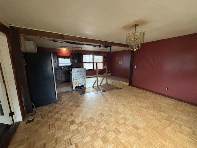 interior space featuring beamed ceiling, a notable chandelier, sink, and light parquet floors