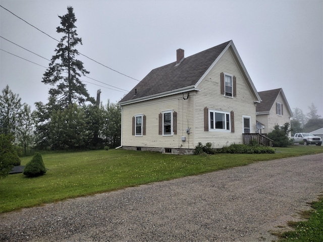 view of property exterior featuring a lawn