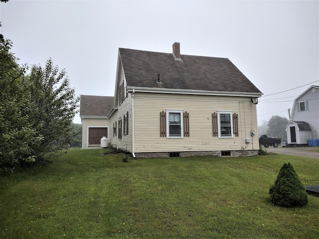 back of property featuring a lawn