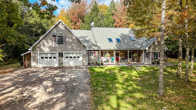 cape cod house with a garage, covered porch, and a front lawn