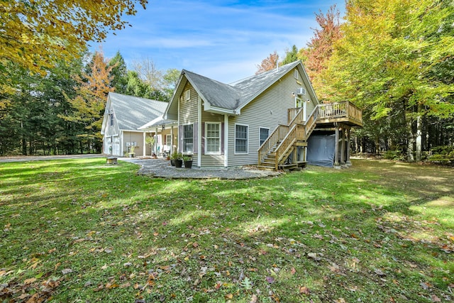 view of side of home featuring a yard and a wooden deck