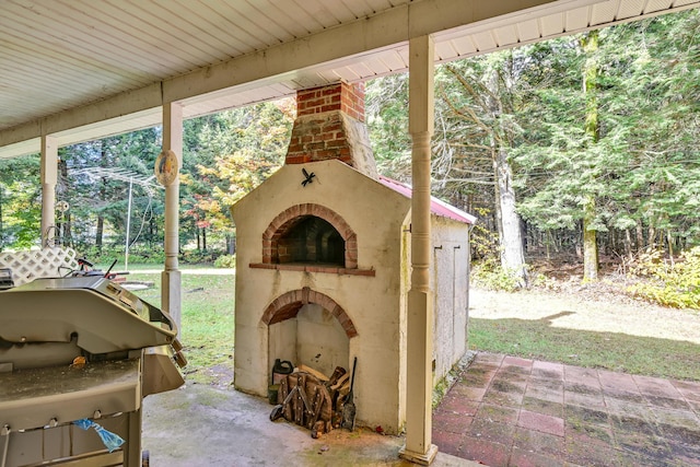 view of patio featuring a grill and exterior fireplace