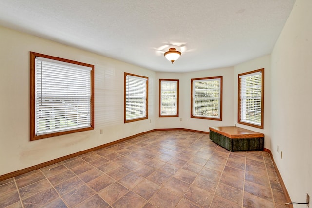 empty room featuring a textured ceiling