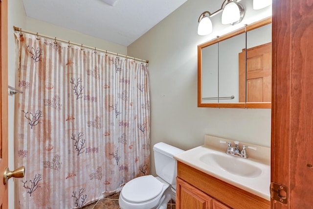 bathroom featuring tile patterned floors, vanity, and toilet